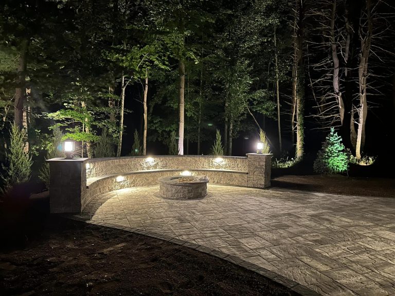 A beautiful hardscape patio in Clifton Park, NY, featuring a fire pit and seating area.
