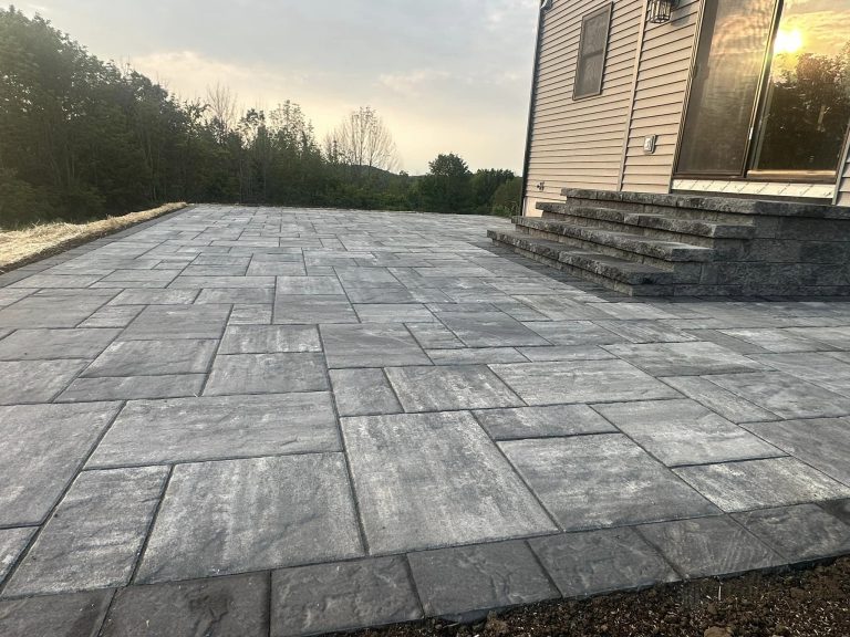 A professionally designed paver patio in Halfmoon, NY, with outdoor lighting.